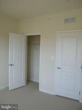 an empty room with closet area