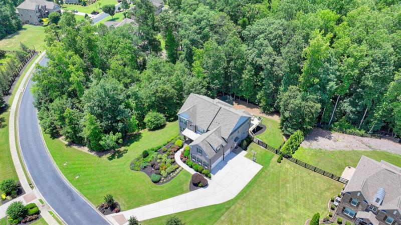 an aerial view of a house with a yard and outdoor seating