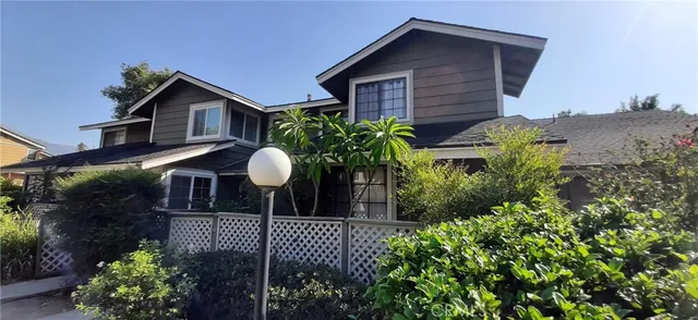 a front view of a house with a yard and plants