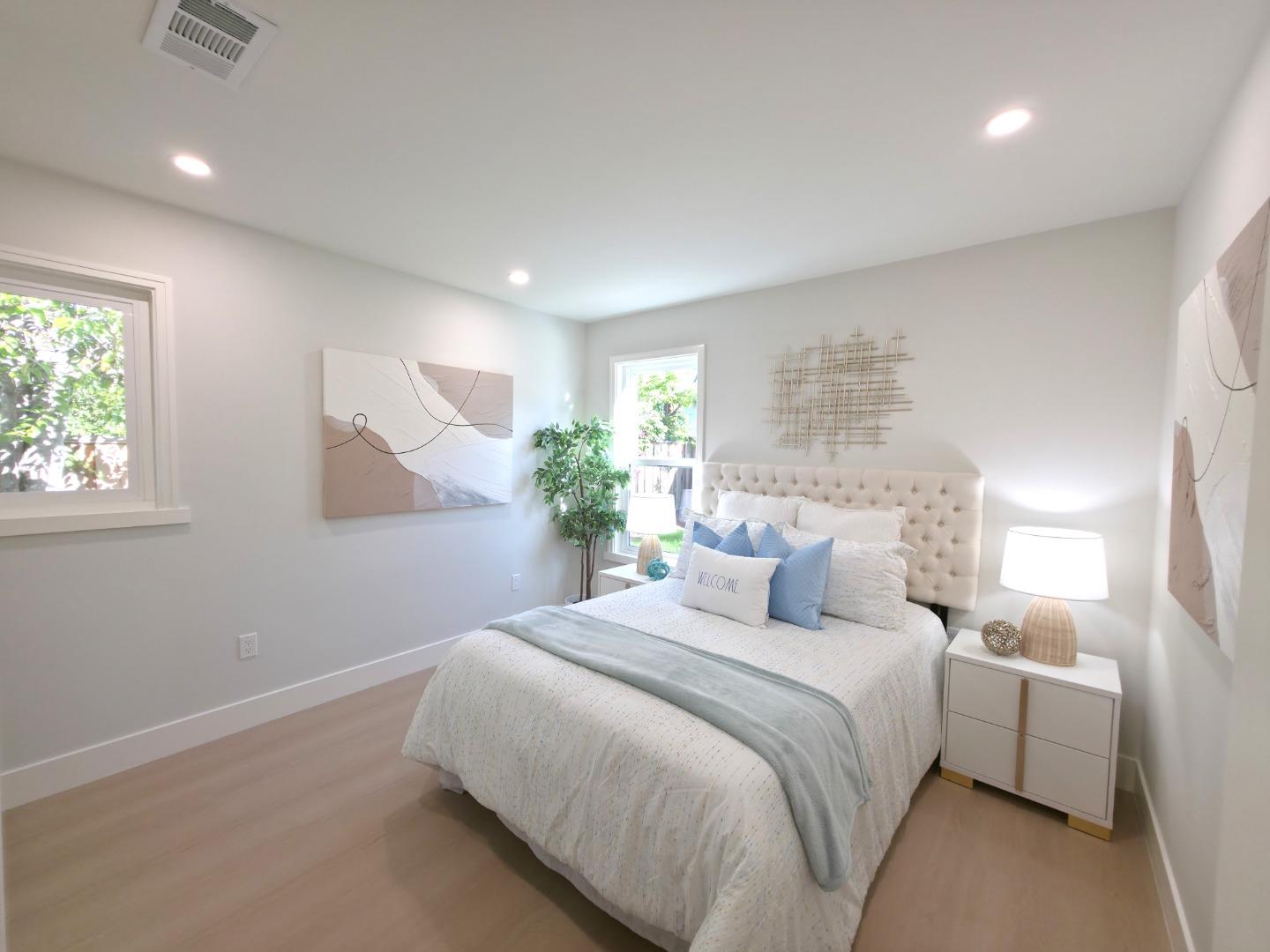 6746 Bollinger Road San Jose, CA 95129 - Photo 15 of 30 a bedroom with a large bed and a potted plant