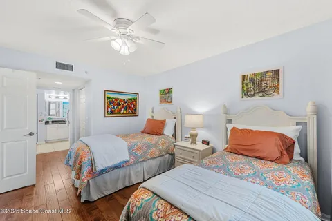 a bathroom with a granite countertop sink a large mirror a toilet and a shower