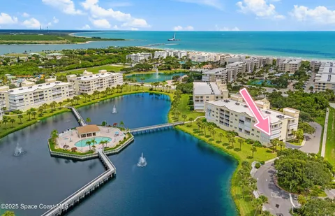 an aerial view of a house with a ocean view