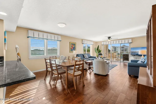 a kitchen with granite countertop a refrigerator and white cabinets