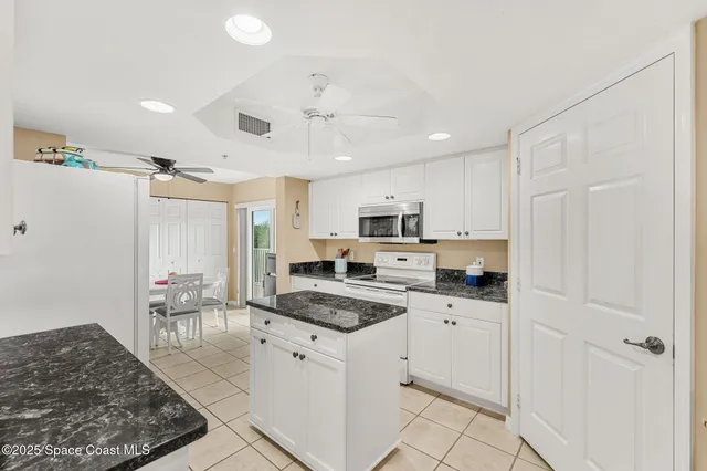 a view of a lake with couches and city view