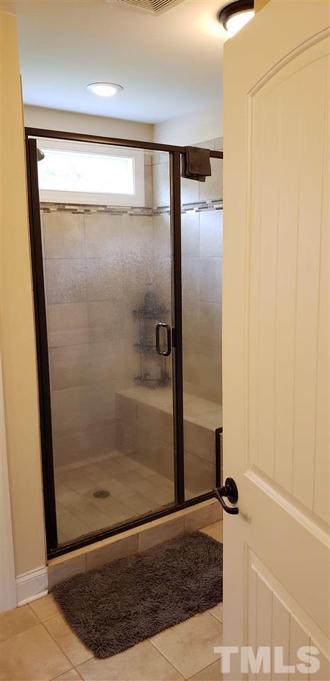 2021 Sageleaf Court Raleigh, NC 27603 - Photo 11 of 20 a bathroom with a shower