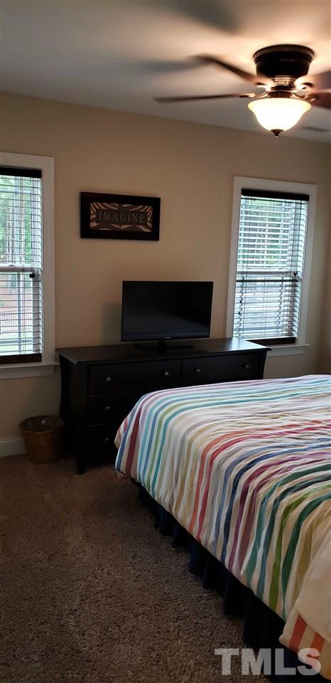 2021 Sageleaf Court Raleigh, NC 27603 - Photo 15 of 20 a bedroom with a bed and a window