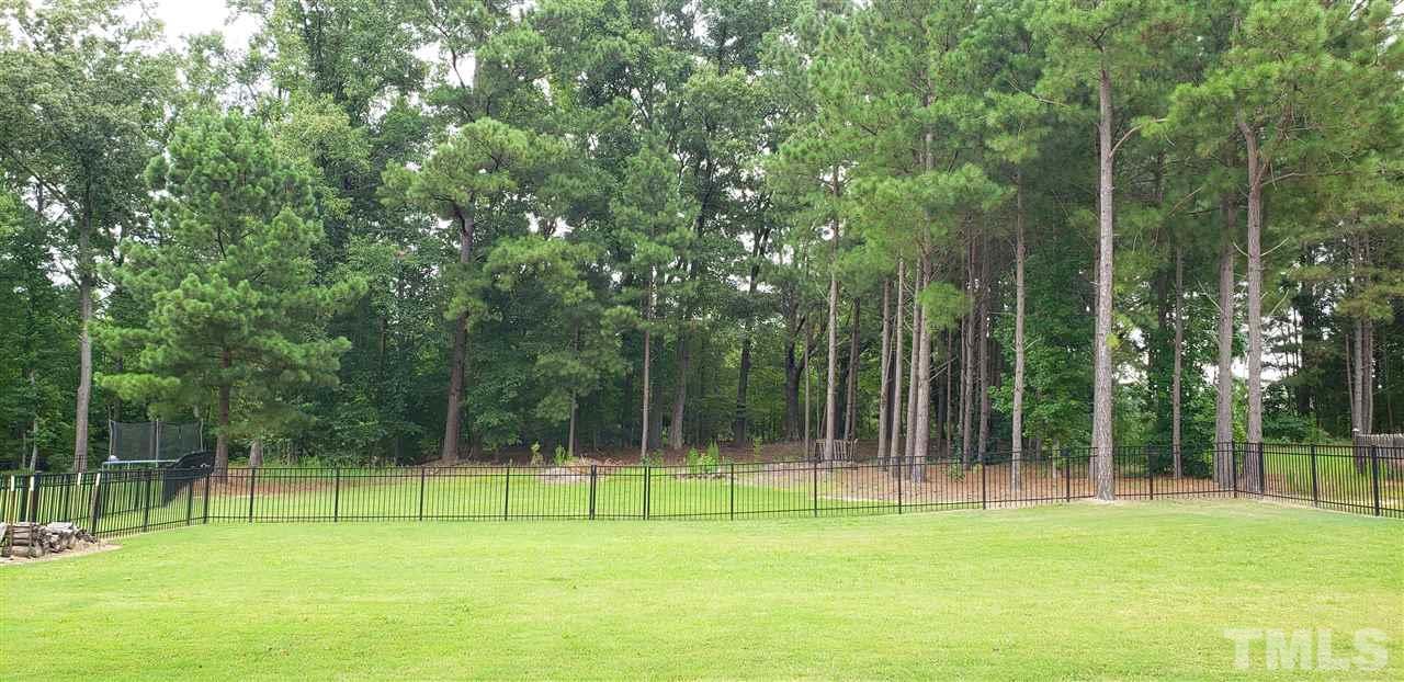 2021 Sageleaf Court Raleigh, NC 27603 - Photo 20 of 20 a view of large trees and a backyard