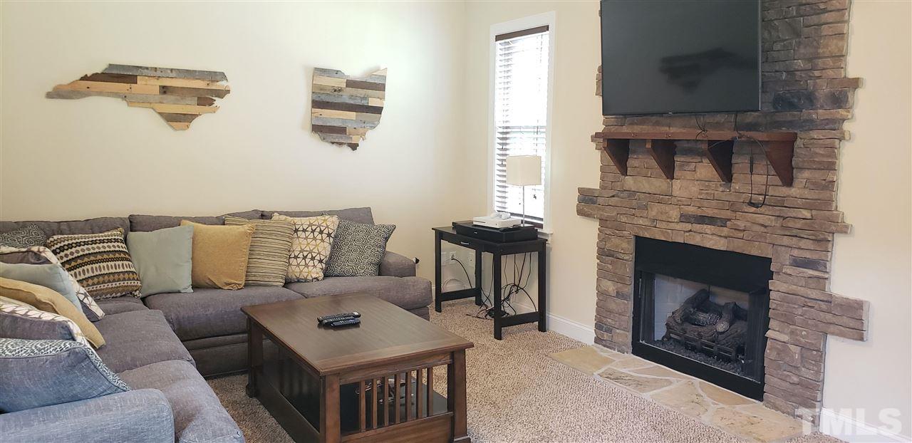 2021 Sageleaf Court Raleigh, NC 27603 - Photo 3 of 20 a living room with furniture and a fireplace