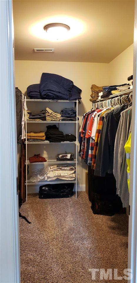2021 Sageleaf Court Raleigh, NC 27603 - Photo 9 of 20 a view of walk in closet with clothes and shoes