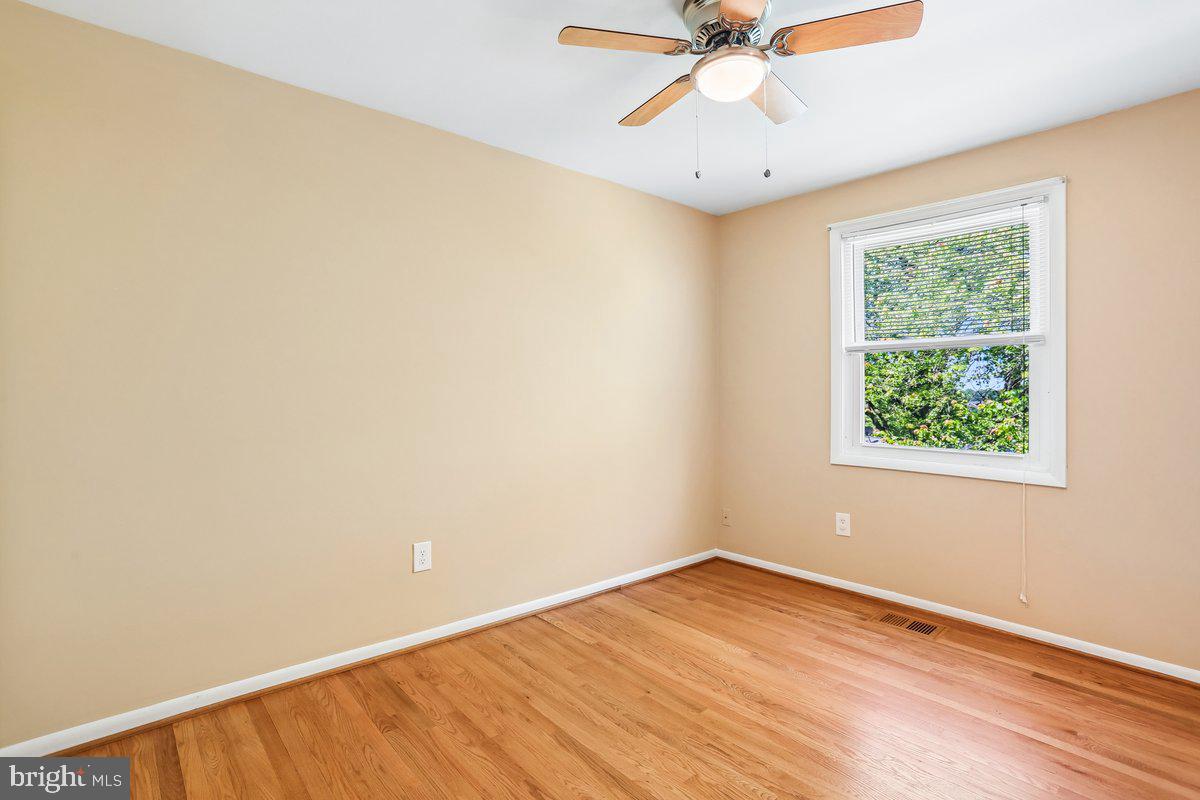 76 Timber Rock Road Gaithersburg, MD 20878 - Photo 29 of 51 an empty room with a window and a ceiling fan