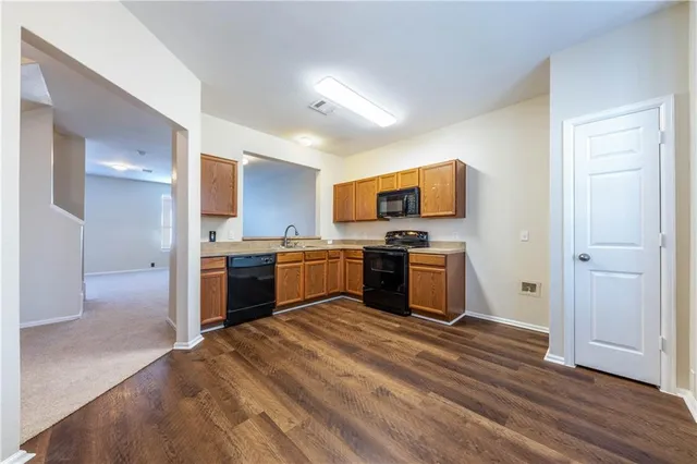 a kitchen with a sink and stainless steel appliances