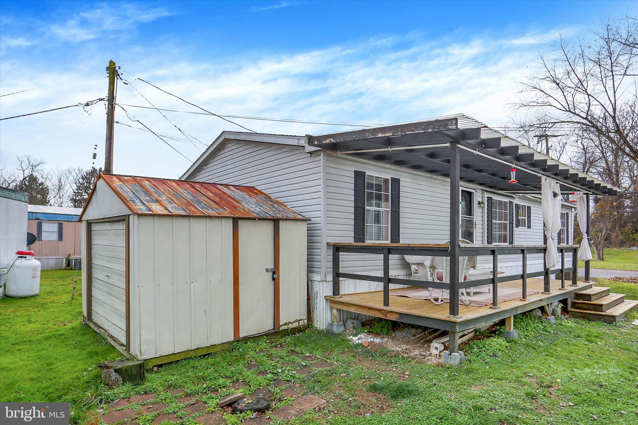1550 Williams Grove Road, Unit 101 Dillsburg, PA 17019 - Photo 20 of 22 a view of a house with a yard and deck area under a large tree