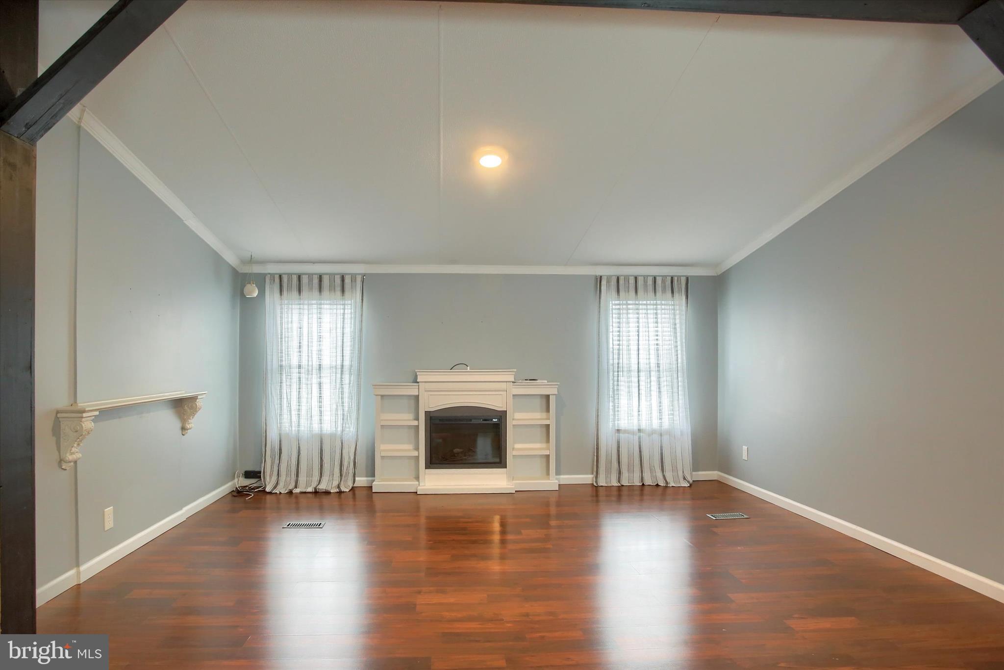 1550 Williams Grove Road, Unit 101 Dillsburg, PA 17019 - Photo 8 of 22 a view of an empty room with wooden floor and a window
