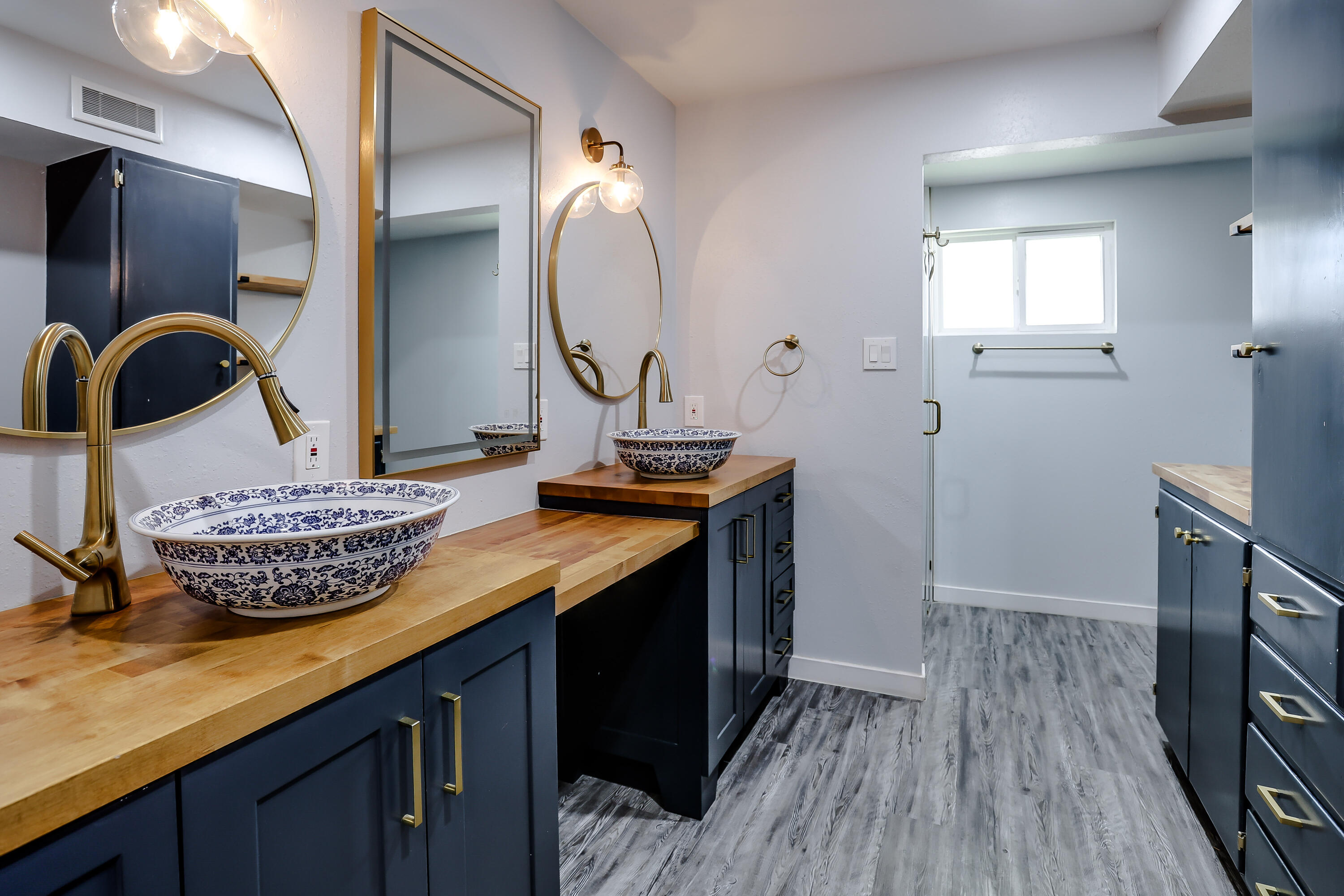 3615 47th Street Lubbock, TX 79413 - Photo 17 of 36 a bathroom with a granite countertop sink a mirror and vanity