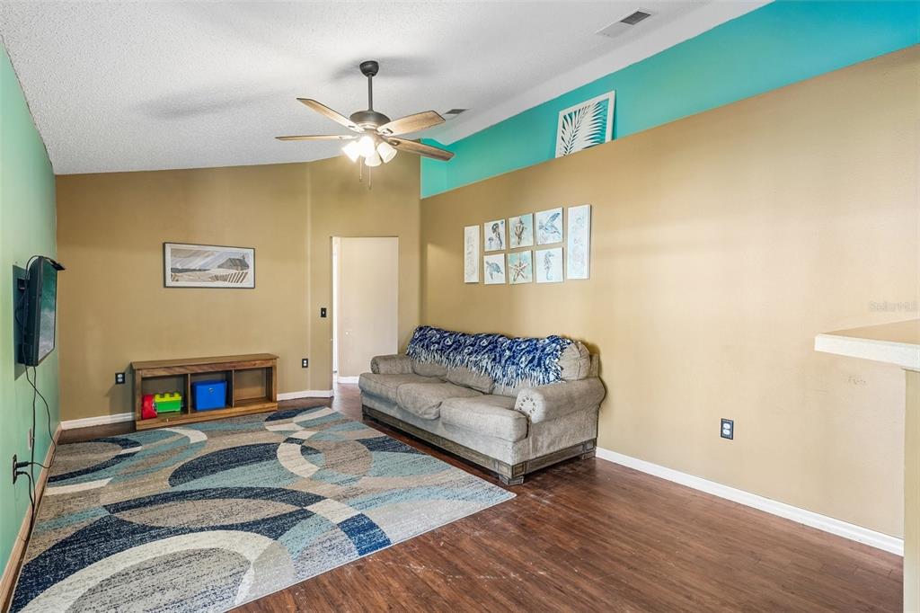 10303 Fordham Street Spring Hill, FL 34608 - Photo 10 of 25 a living room with furniture and a fireplace