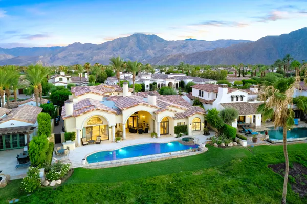 a view of multiple houses with swimming pool