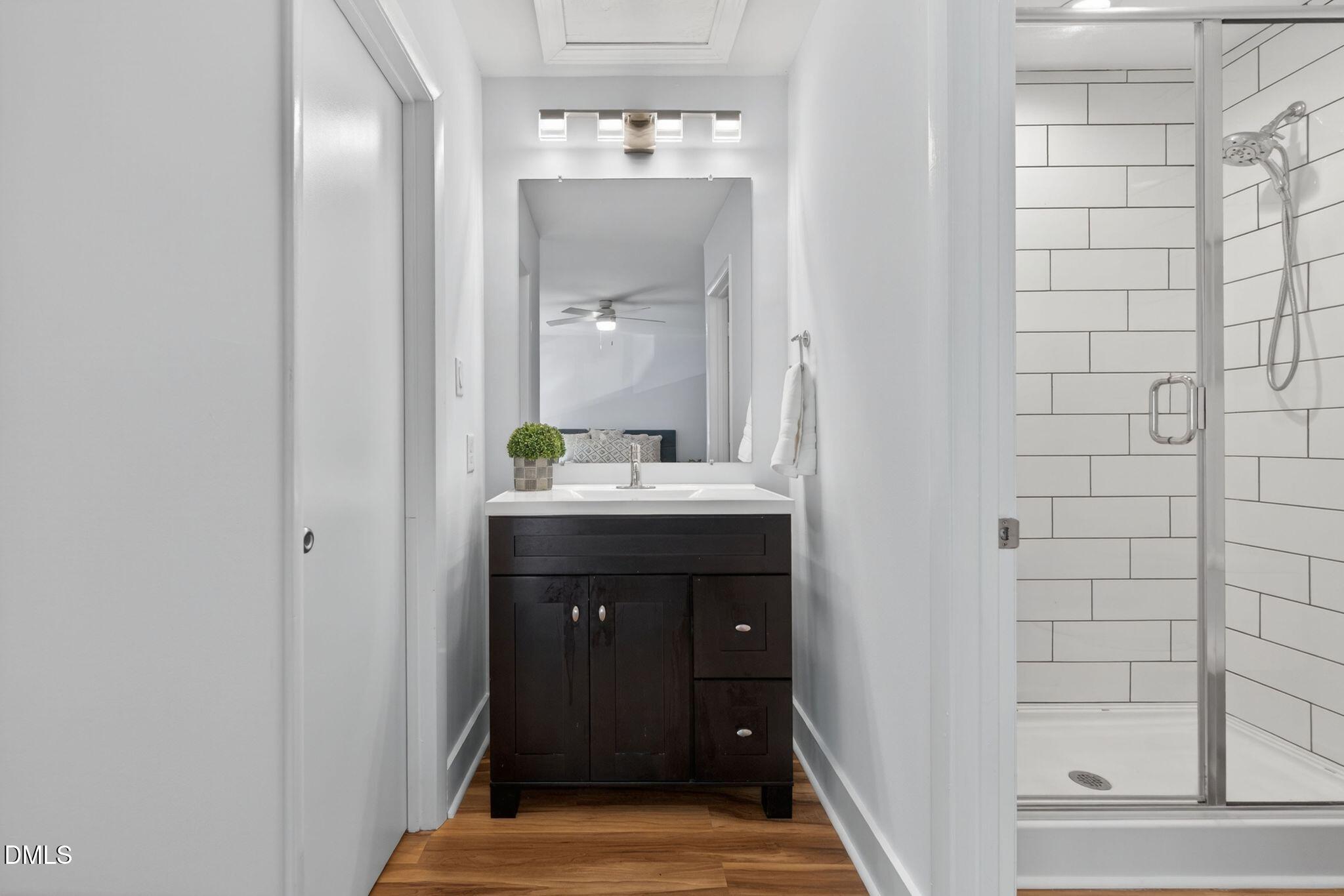 7149 Sandy Creek Drive Raleigh, NC 27615 - Photo 15 of 23 a bathroom with a sink and a mirror