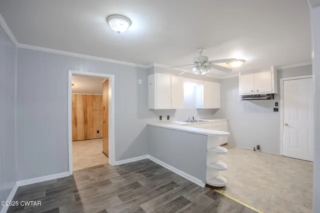 a view of a kitchen with a sink and a window