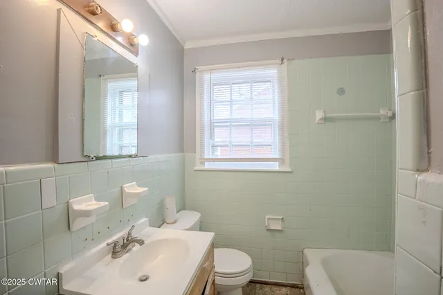 a bathroom with a sink mirror and toilet