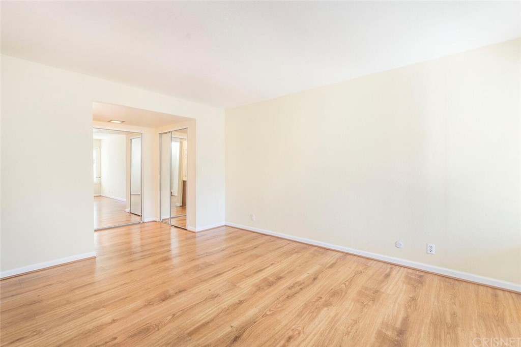 27003 Rio Prado Drive Valencia, CA 91354 - Photo 13 of 27 a view of an empty room with wooden floor and a window