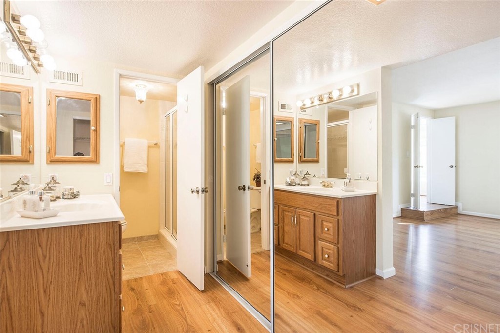 27003 Rio Prado Drive Valencia, CA 91354 - Photo 14 of 27 a bathroom with a double vanity sink and mirror