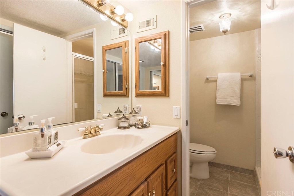 27003 Rio Prado Drive Valencia, CA 91354 - Photo 15 of 27 a bathroom with a sink toilet and shower