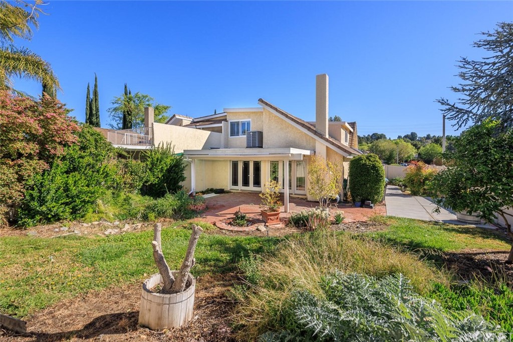 27003 Rio Prado Drive Valencia, CA 91354 - Photo 23 of 27 a front view of a house with a garden and plants
