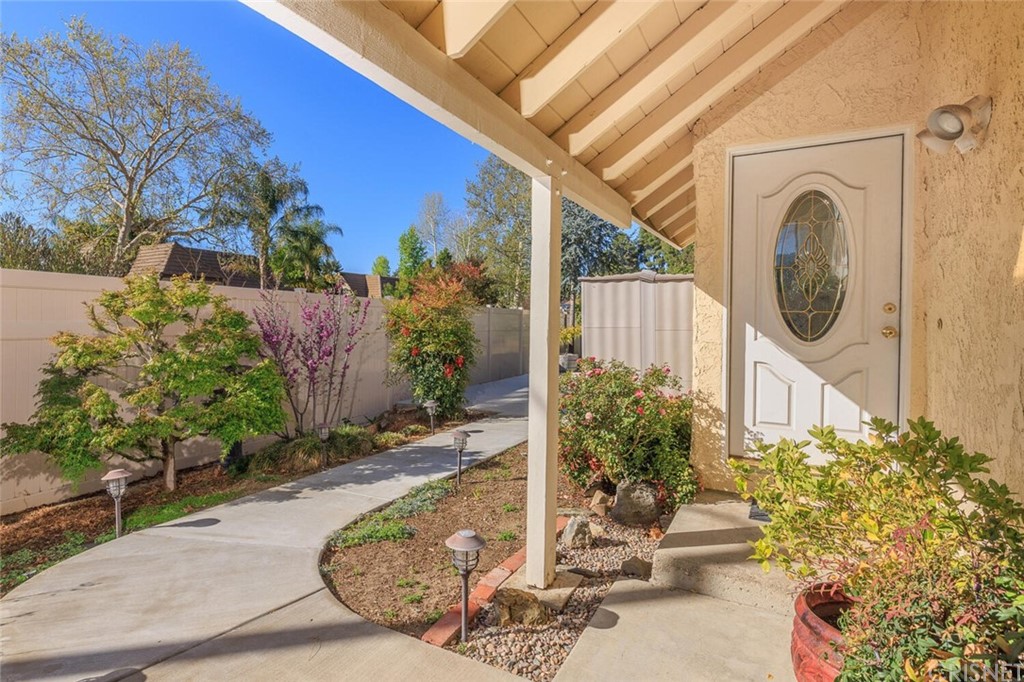 27003 Rio Prado Drive Valencia, CA 91354 - Photo 4 of 27 a view of a garden with chair and flower plants