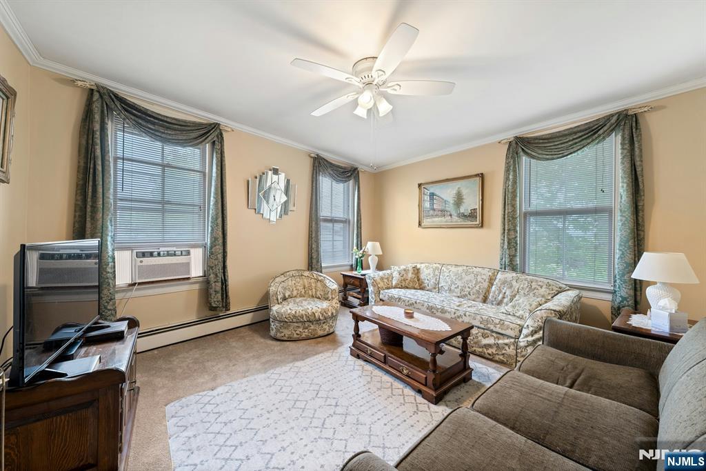 79 Washington Street Harrison, NJ 07029 - Photo 9 of 25 a living room with furniture and a flat screen tv