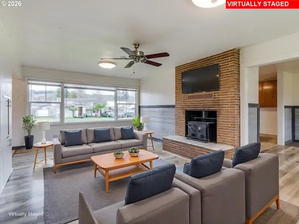 a living room with furniture a large window and a fireplace
