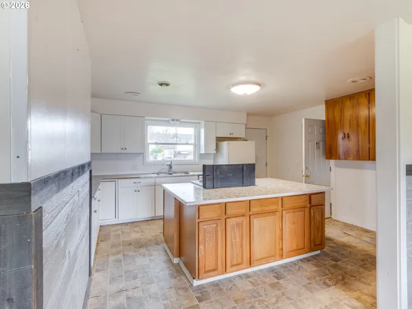 a kitchen that has a sink and a stove in it