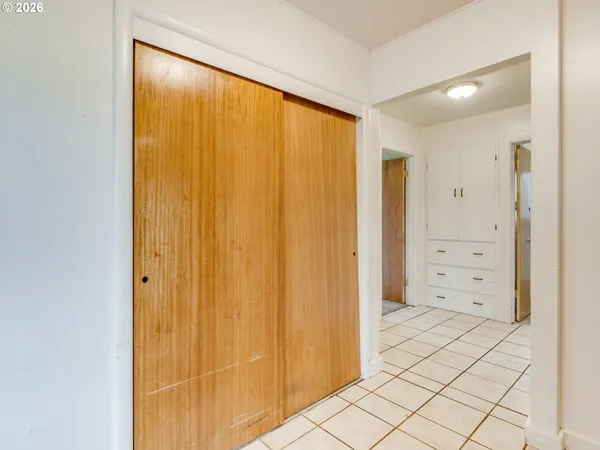 a view of a bathroom with mirror and shower