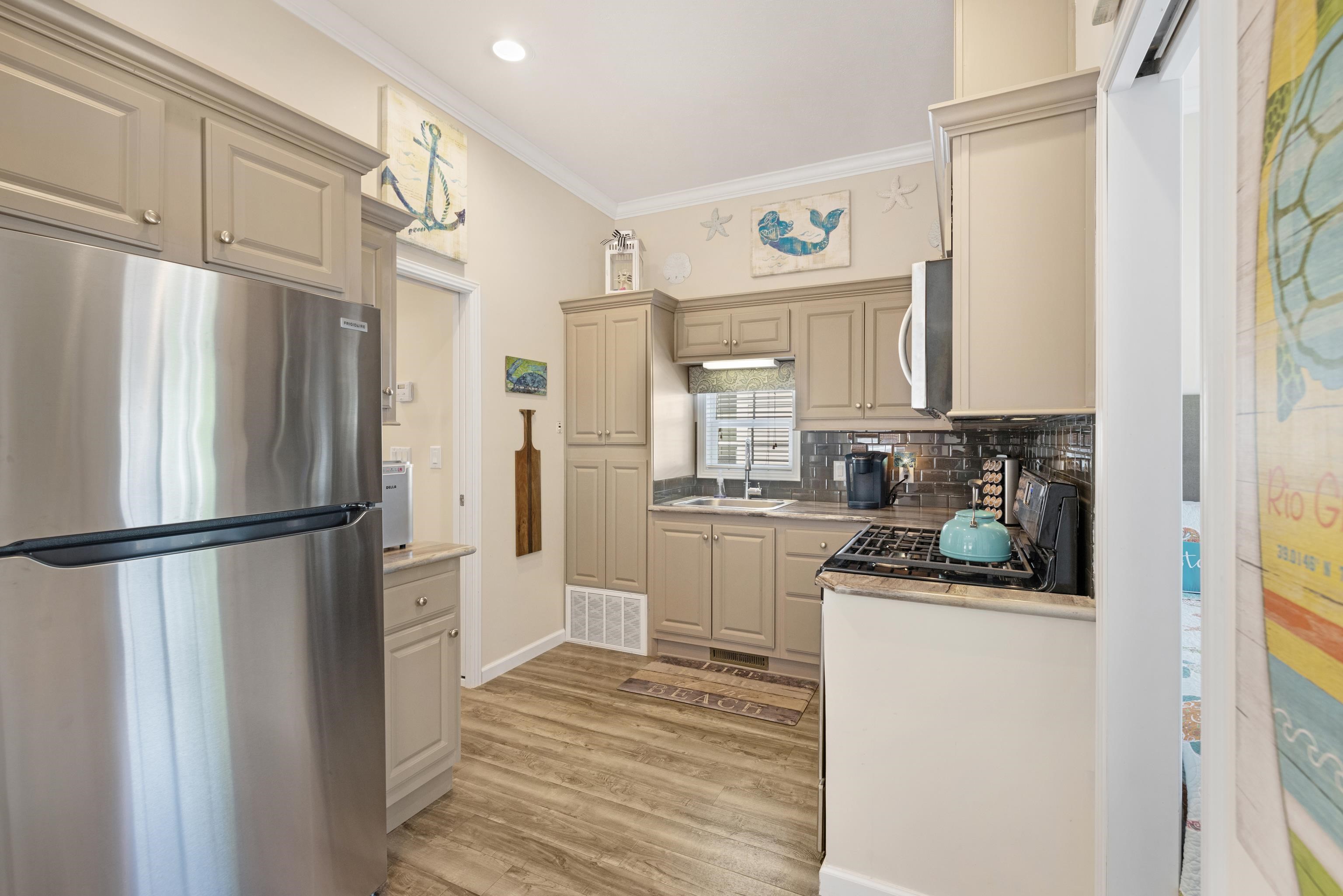 4100 Rte 9 South, Unit 88 Rio Grande, NJ 08242 - Photo 12 of 38 a kitchen with stainless steel appliances a refrigerator sink and cabinets