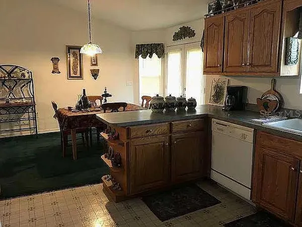 a kitchen with a sink a stove a microwave and cabinets