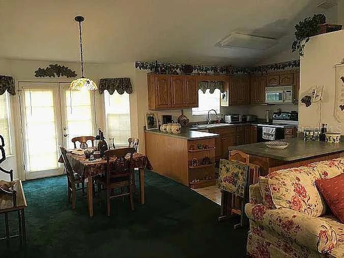363 Southwest Monroe Avenue Mayo, FL 32066 - Photo 7 of 12 a kitchen with stainless steel appliances granite countertop a stove a sink and a refrigerator