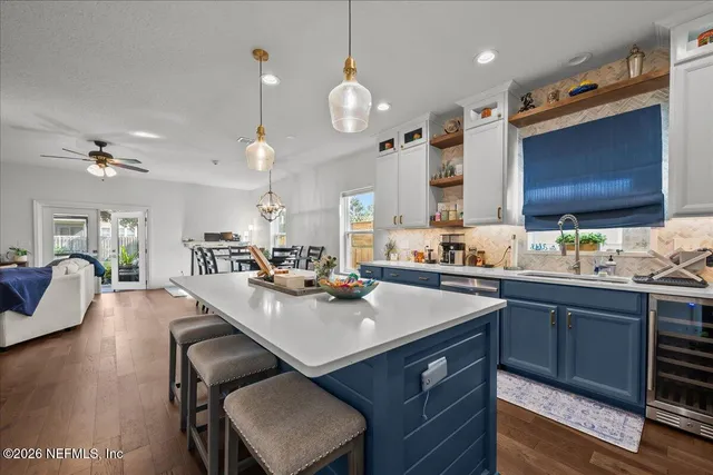 a kitchen with a table chairs sink and cabinets