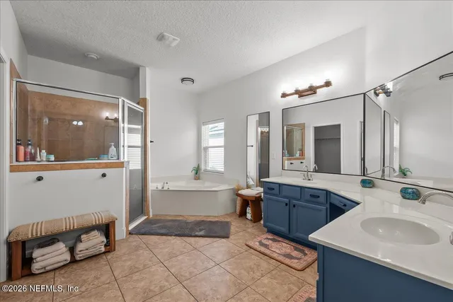 a large bathroom with a double vanity sink and a mirror