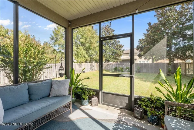 a view of a house with backyard and a tree