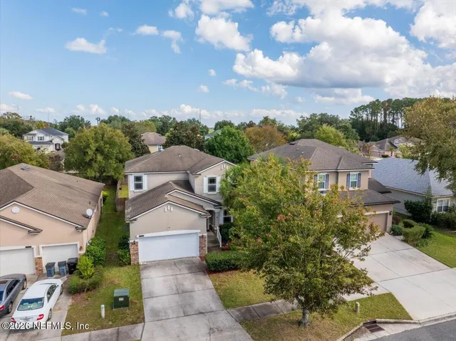 an aerial view of residential house with outdoor space and swimming pool