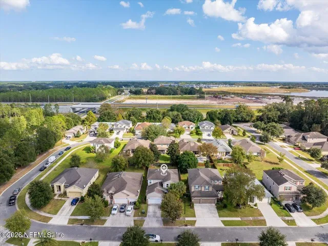 an aerial view of residential houses with outdoor space