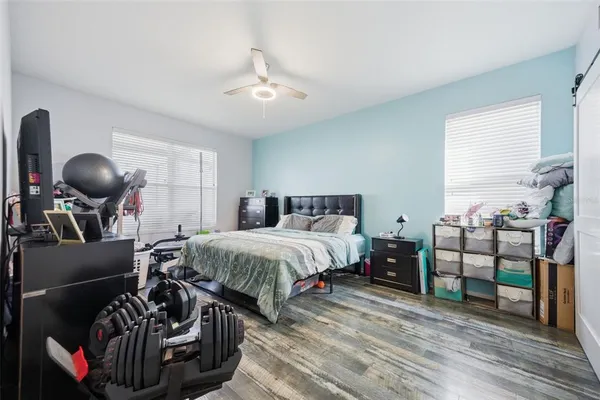 a bedroom with bed and a chandelier