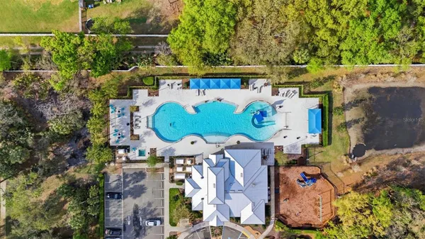 an aerial view of a house with garden space and street view