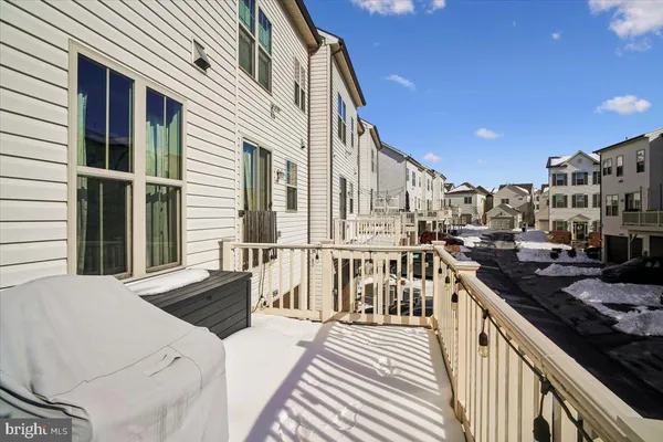 a view of a balcony with wooden floor and seating space