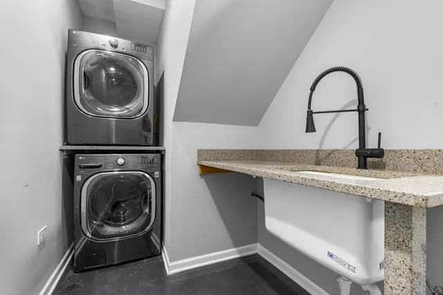 a close view of a sink and a washer and dryer in a room