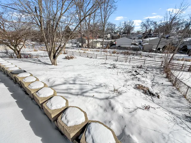 a view of swimming pool with seating area and trees