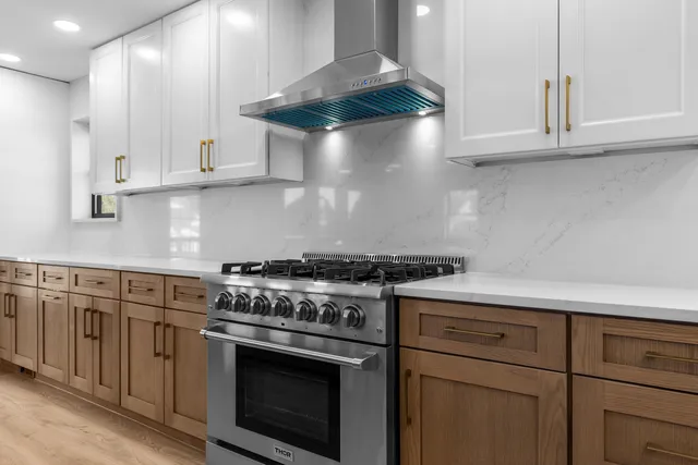 a white stove top oven sitting inside of a kitchen