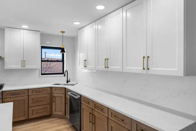 a kitchen with a sink cabinets and window