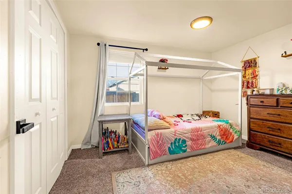 a bedroom with bed and a window