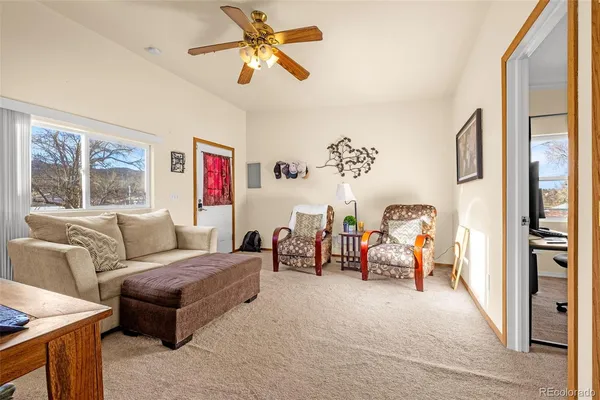 a living room with furniture a window and a flat screen tv