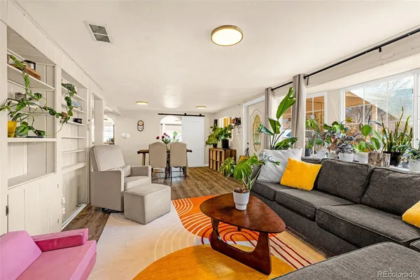 a living room with furniture a rug and a chandelier